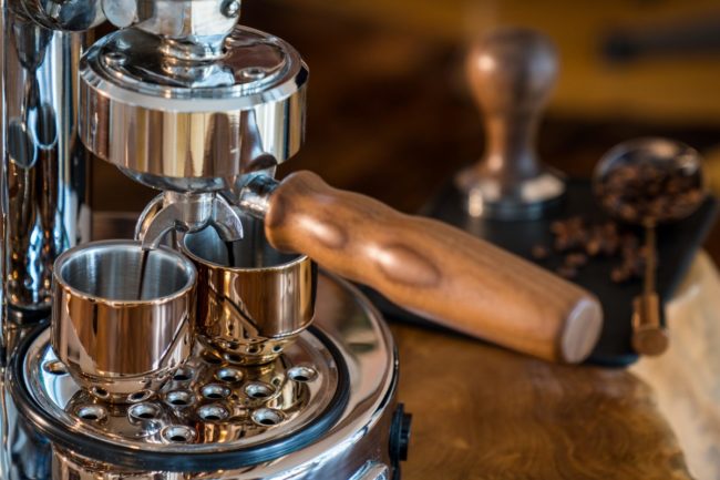Pouring fresh espresso with high end Barista Espresso Machine at home