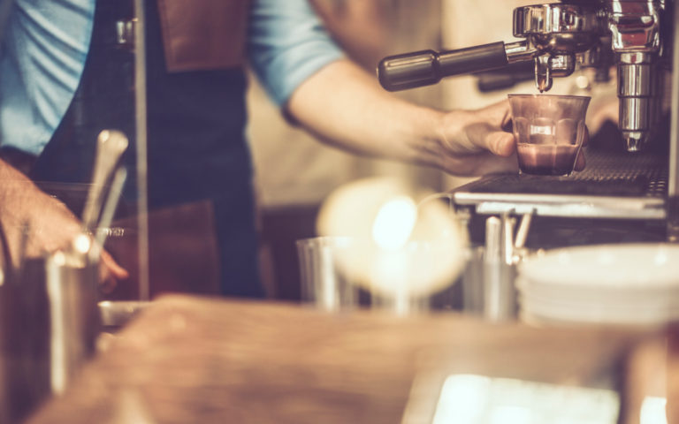 young-barista-is-making-a-coffee